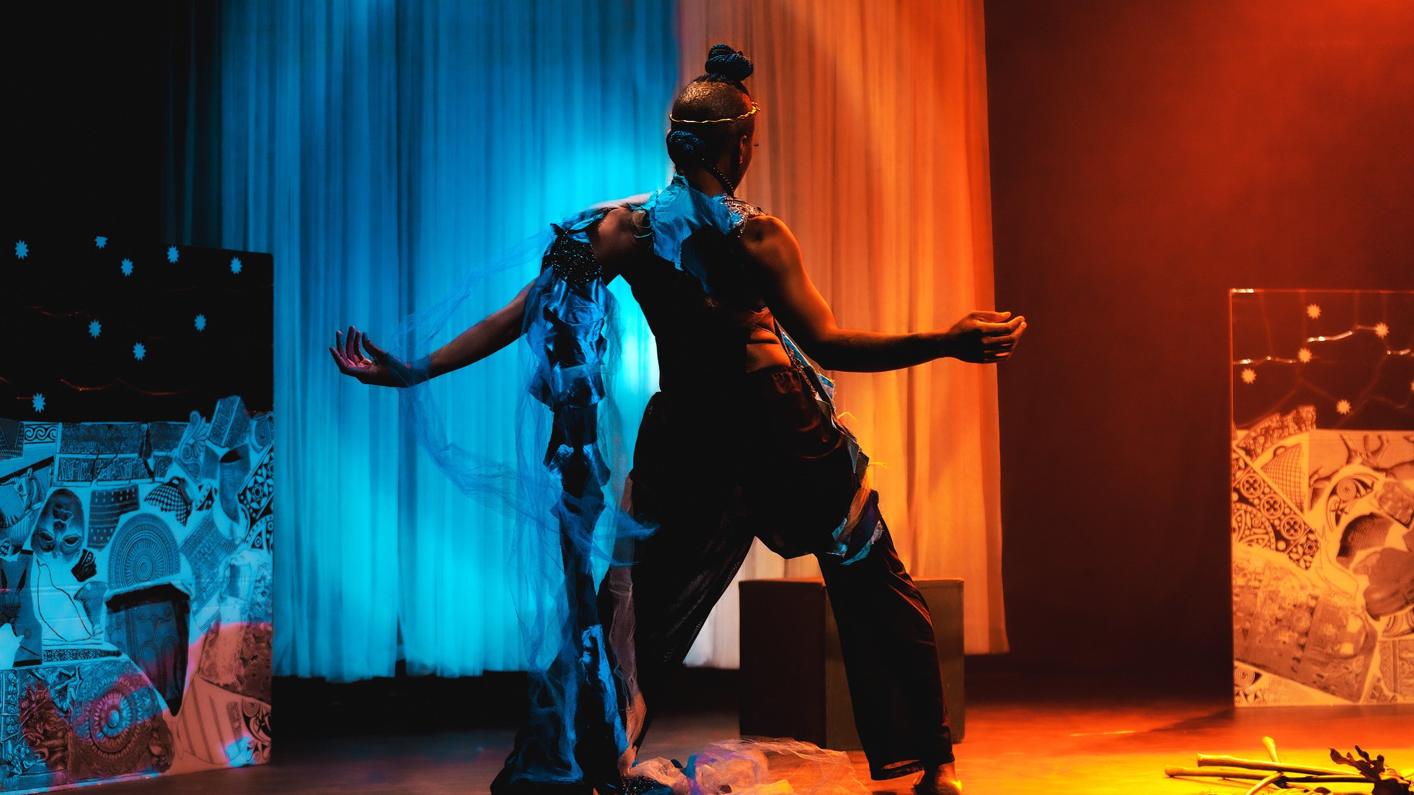 A picture from The New Embassy series, featuring Jaz Fairy J dancing on a stage lit with blue and orange lights.